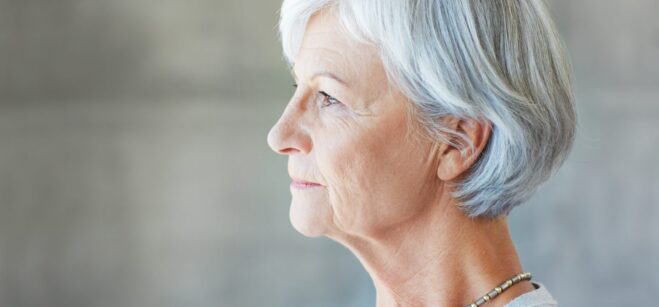 A woman with grey hair in profile.
